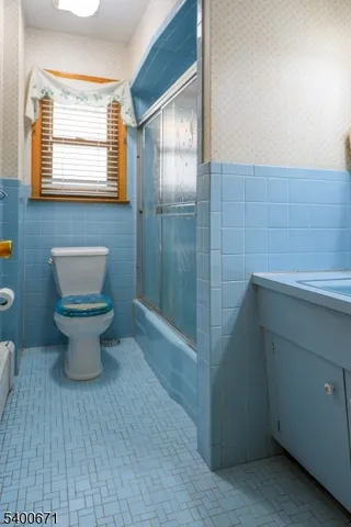 a bathroom with a toilet sink and shower