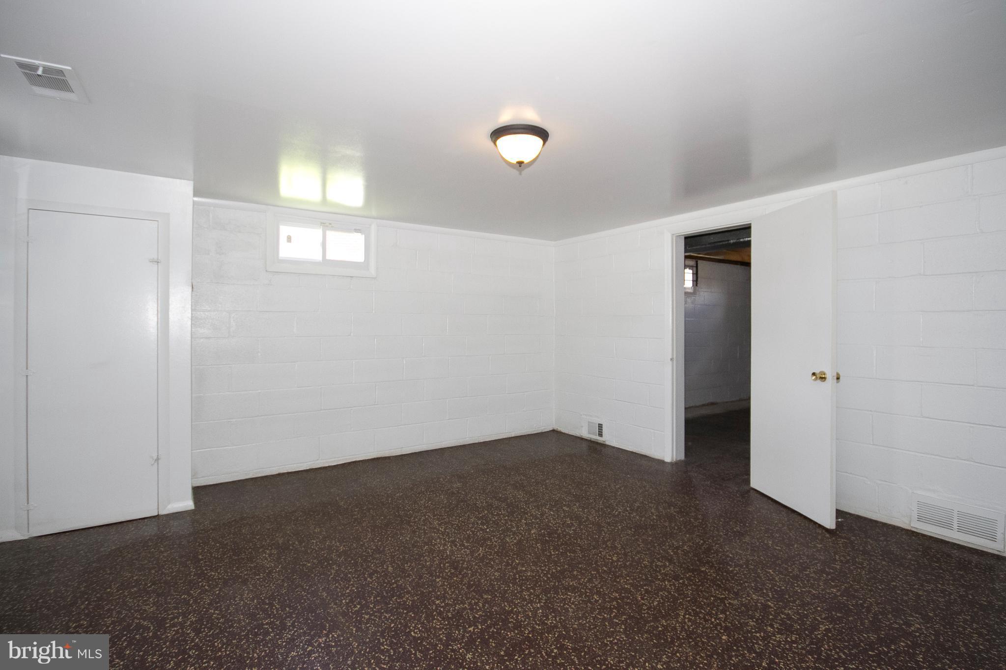 6936 Blanche Road Baltimore, MD 21215 - Photo 14 of 15 an empty room with windows and closet
