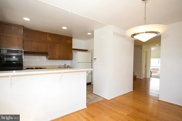 a kitchen with stainless steel appliances granite countertop a refrigerator a sink and a stove