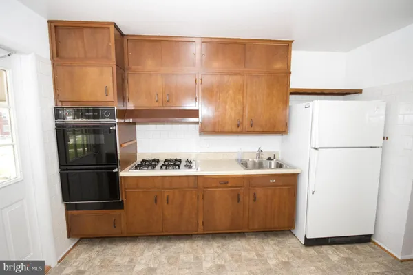 a kitchen with a refrigerator and a sink