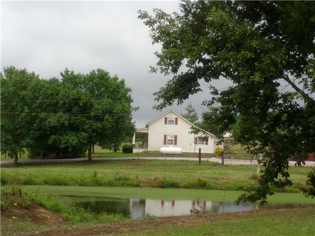 2835 Dunlap Road Duck River, TN 38454 - Photo 2 of 18 Side view of home. This small pond seen in this picture is fed by a year round spring.