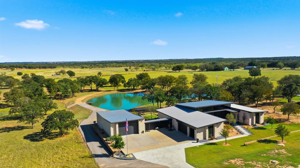 a view of a terrace with lawn chairs