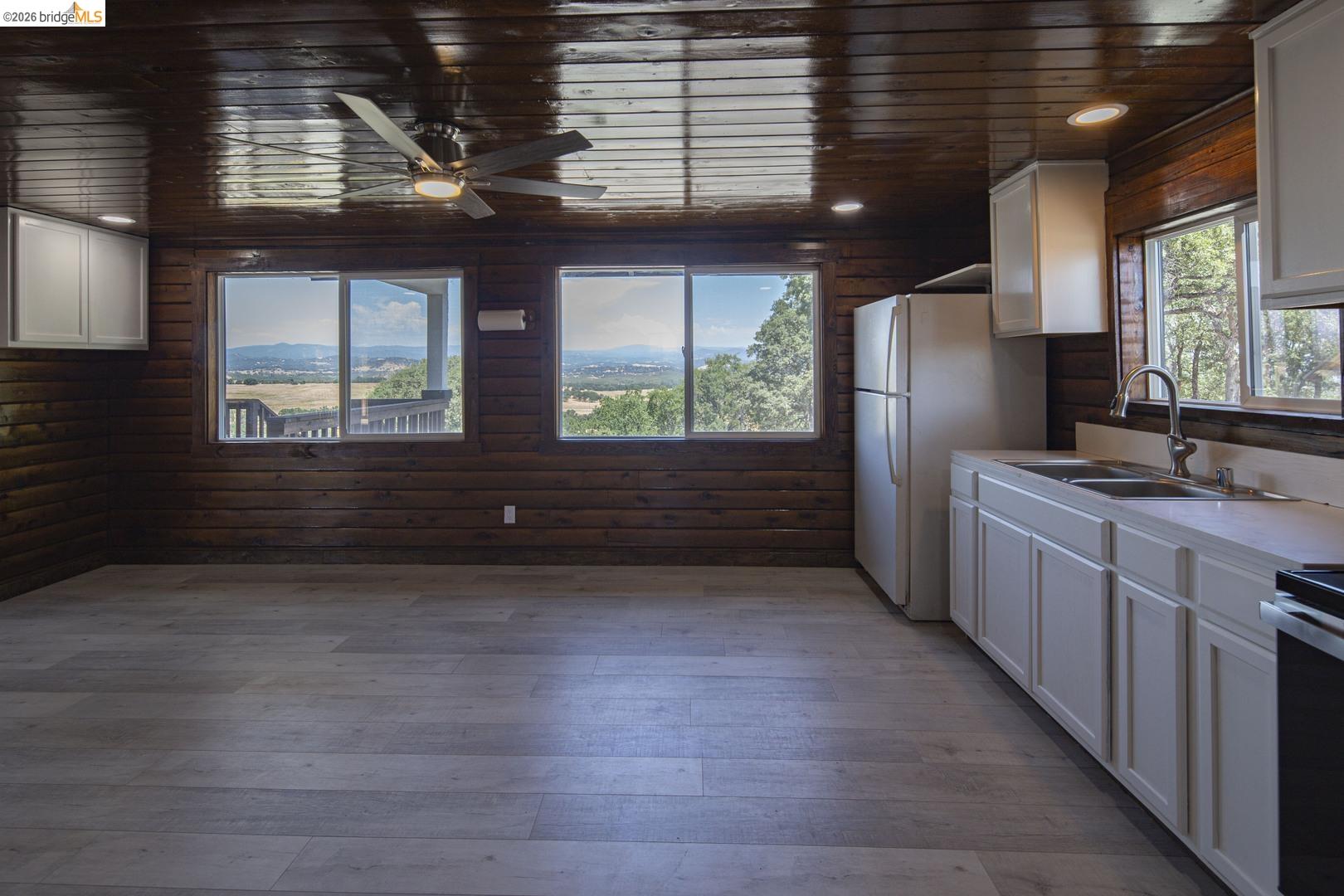 14594 Perricone Road Jamestown, CA 95327 - Photo 16 of 39 a kitchen with kitchen island wooden cabinets a sink a window and stainless steel appliances