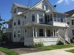 a view of a building with a yard