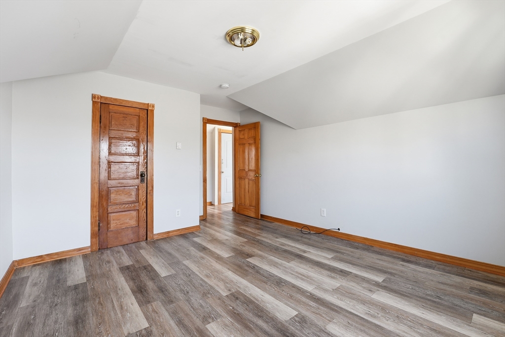 104-106 Madison Street Chicopee, MA 01020 - Photo 16 of 42 a view of an empty room with window and wooden floor