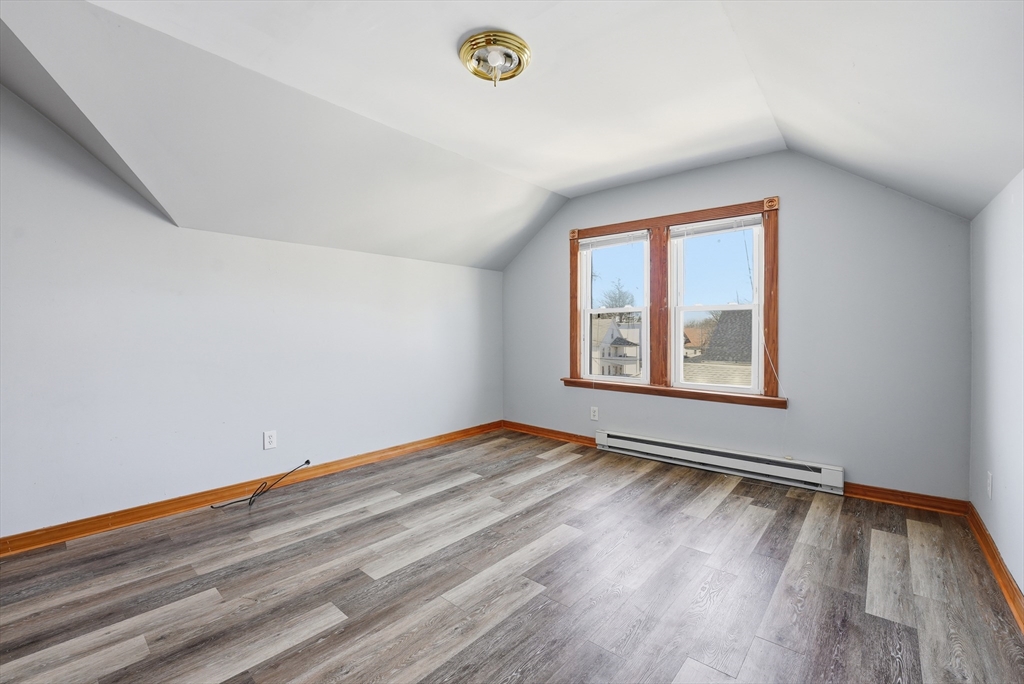 104-106 Madison Street Chicopee, MA 01020 - Photo 17 of 42 a view of an empty room with window and wooden floor