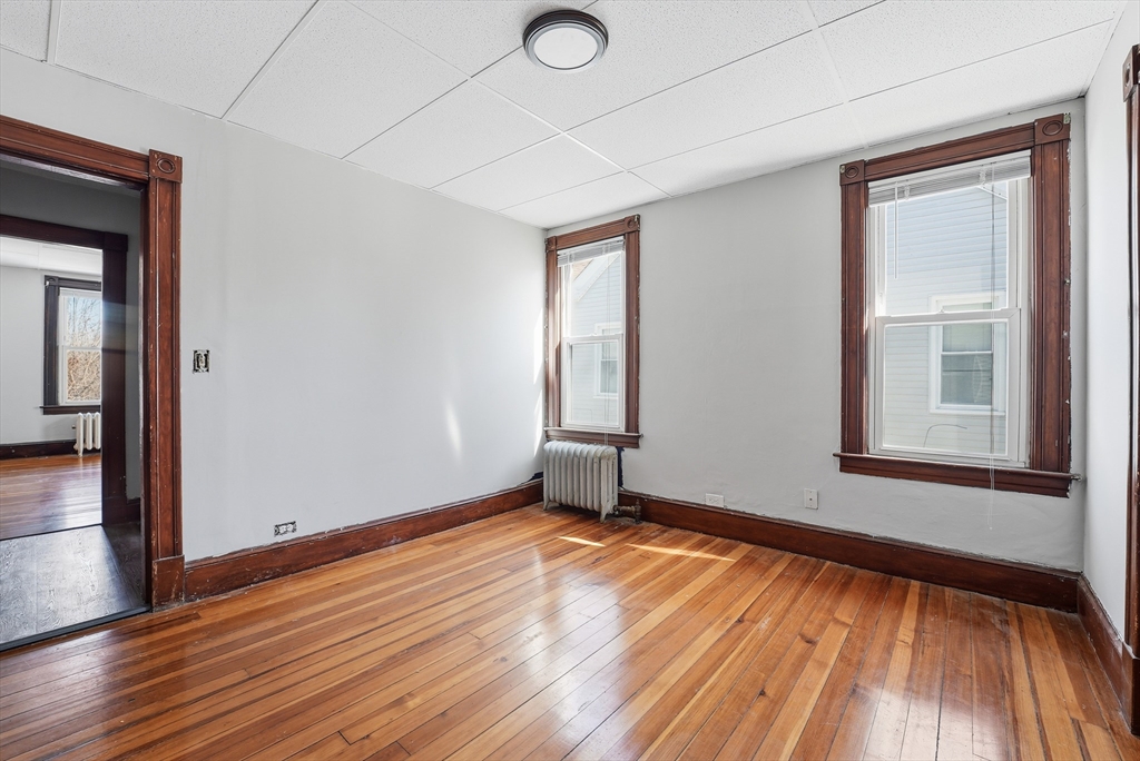 104-106 Madison Street Chicopee, MA 01020 - Photo 21 of 42 a view of empty room with wooden floor and fan