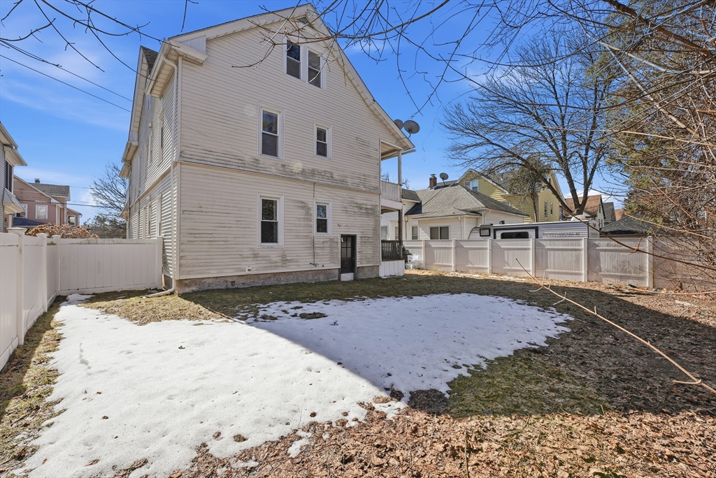 104-106 Madison Street Chicopee, MA 01020 - Photo 34 of 42 a view of a white house with a snow on the road