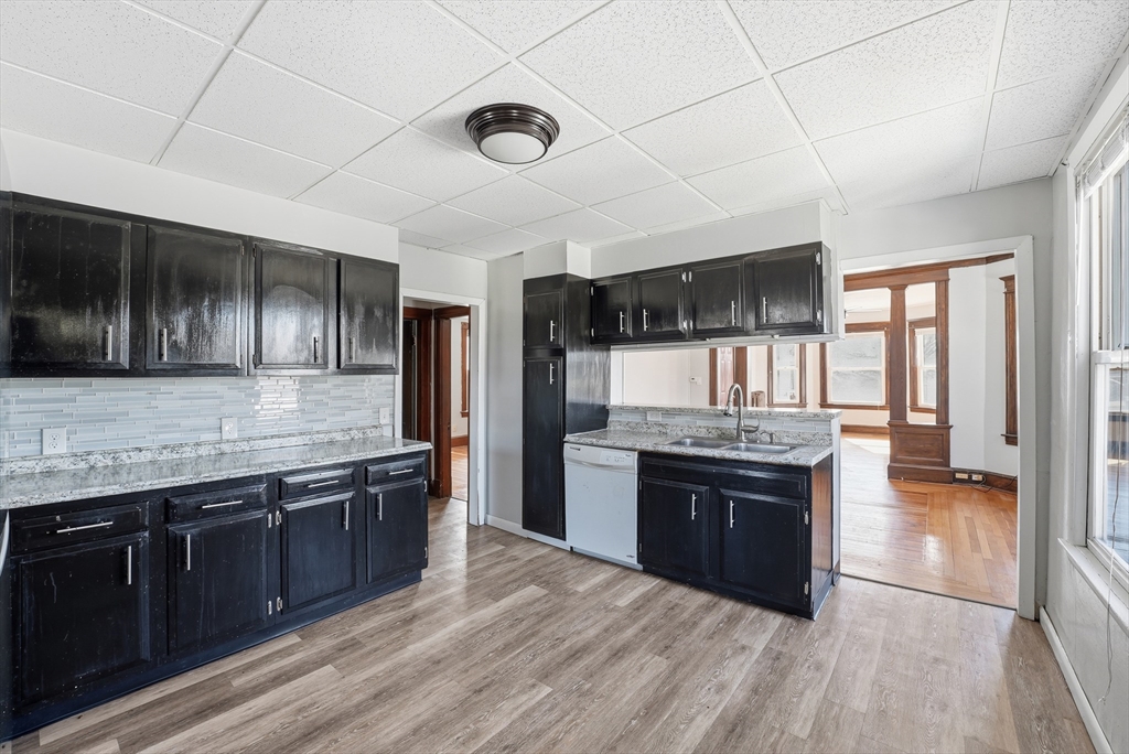 104-106 Madison Street Chicopee, MA 01020 - Photo 40 of 42 a large kitchen with stainless steel appliances granite countertop a stove and a sink