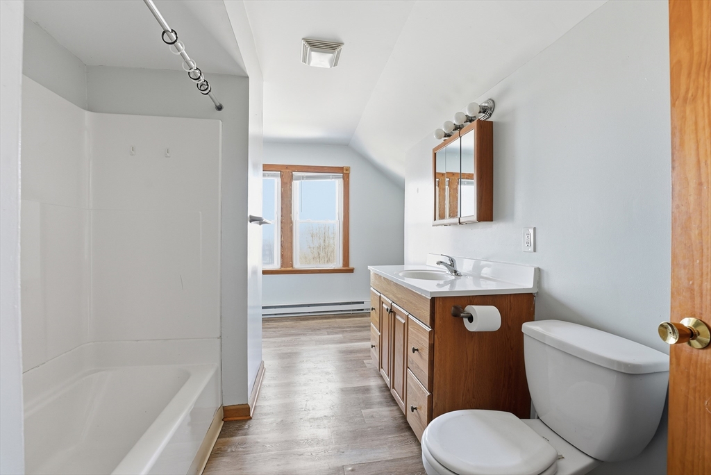 104-106 Madison Street Chicopee, MA 01020 - Photo 10 of 42 a bathroom with a sink toilet vanity and bathtub