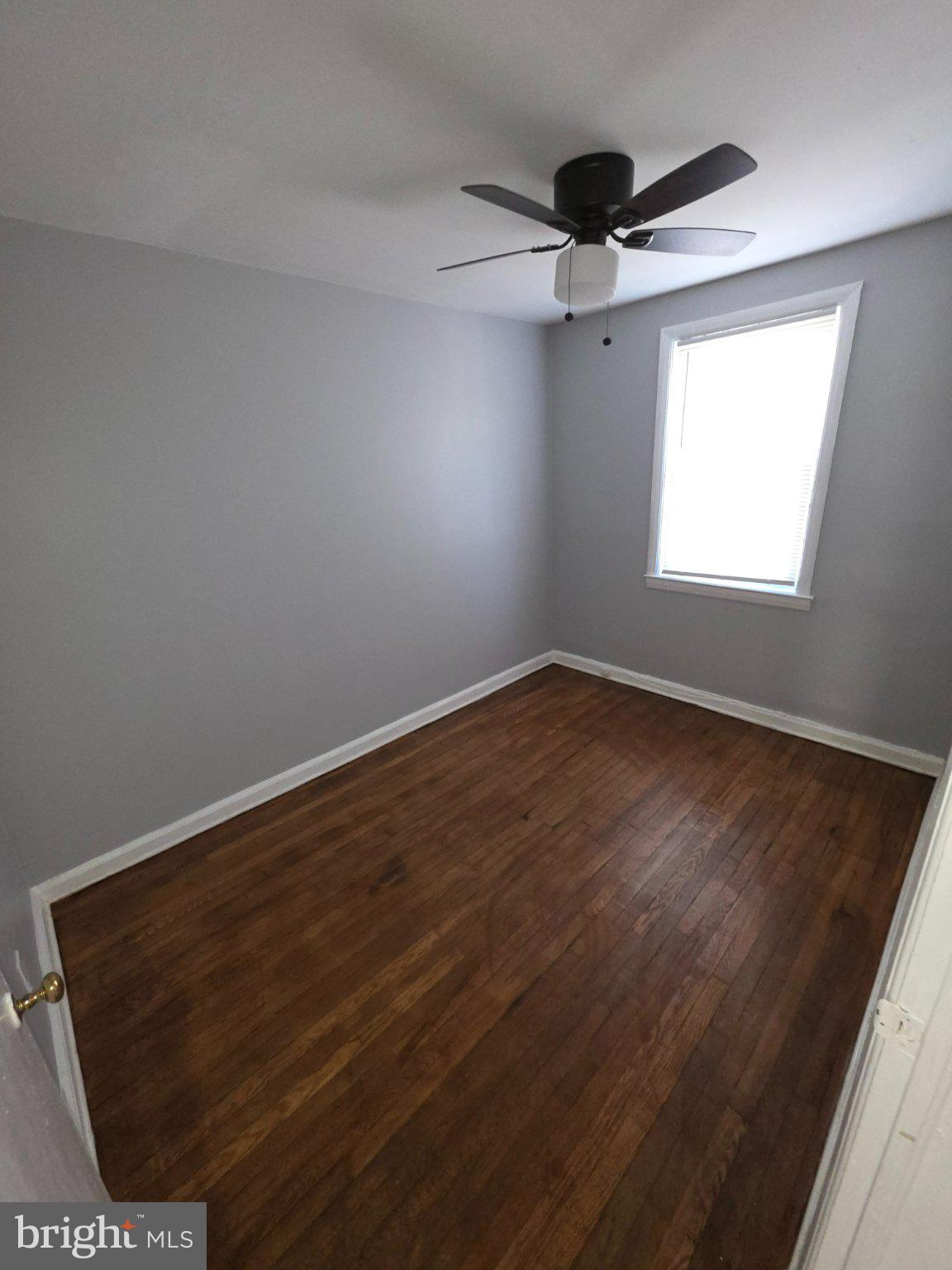 4404 Mountview Road Baltimore, MD 21229 - Photo 14 of 22 an empty room with wooden floor and windows