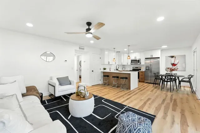 a living room with furniture and kitchen view