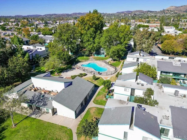 an aerial view of residential houses with city view