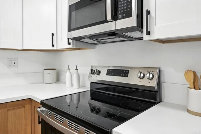 a kitchen with a stove and a microwave