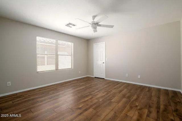wooden floor in an empty room with a window