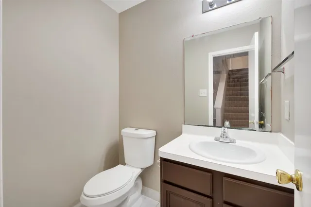 a bathroom with a sink a toilet and mirror