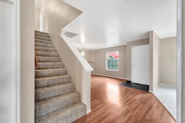 a view of entryway and hall with wooden floor