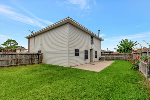 a view of a house with backyard and porch