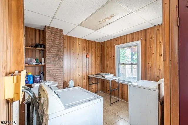 a view of washer and dryer with bathroom in the background
