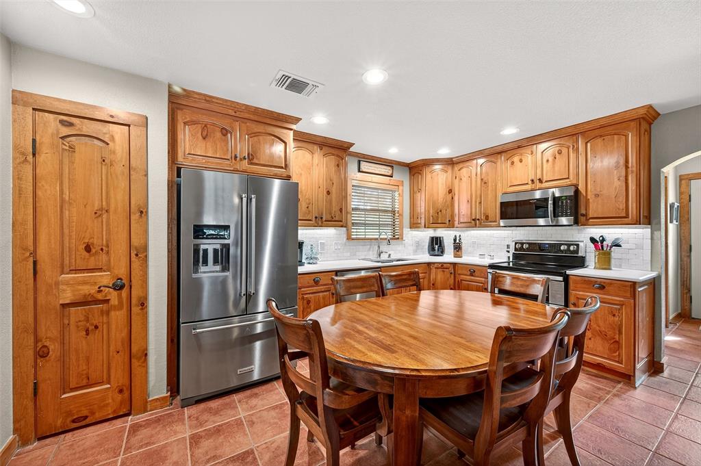 13631 Farm To Market Road 981 Blue Ridge, TX 75424 - Photo 12 of 40 a dining table with stainless steel appliances wooden floor and a window