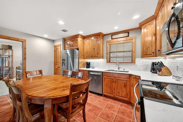 a large kitchen with a table and chairs in it