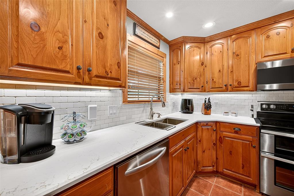 13631 Farm To Market Road 981 Blue Ridge, TX 75424 - Photo 15 of 40 a kitchen with stainless steel appliances a sink dishwasher refrigerator stove and microwave oven