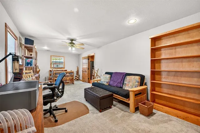 a view of a livingroom with workspace and a couch
