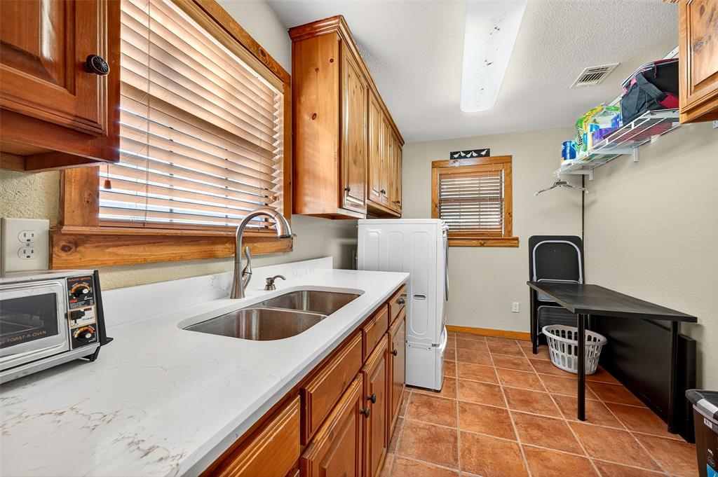 13631 Farm To Market Road 981 Blue Ridge, TX 75424 - Photo 22 of 40 a kitchen with a sink a counter top space and cabinets