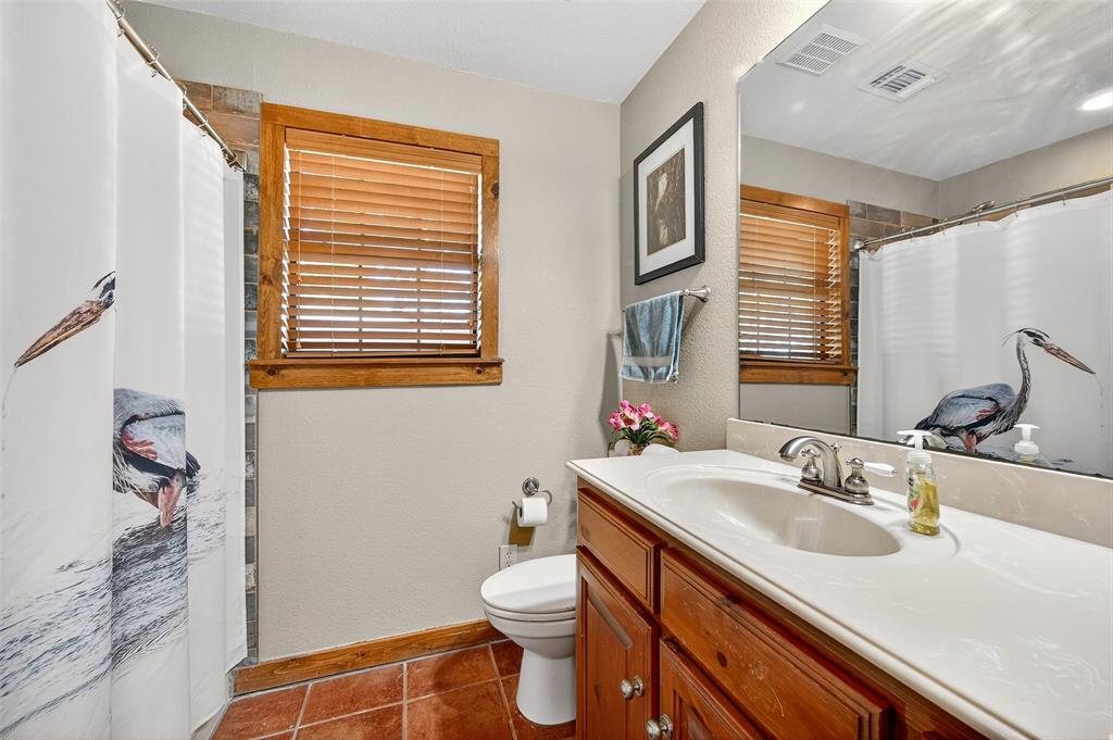 13631 Farm To Market Road 981 Blue Ridge, TX 75424 - Photo 23 of 40 a bathroom with a sink a toilet and a mirror