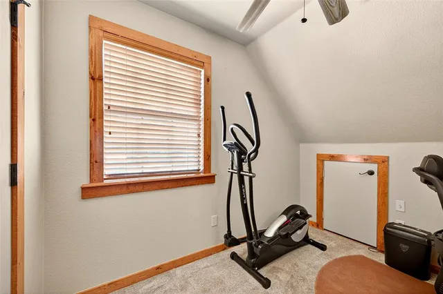 a room with gym equipment and windows