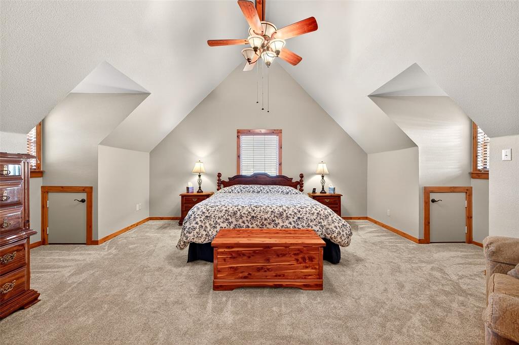 13631 Farm To Market Road 981 Blue Ridge, TX 75424 - Photo 26 of 40 a bedroom with a bed and a chandelier