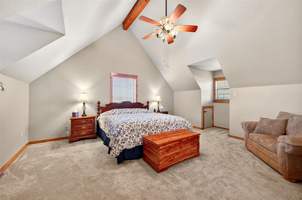 13631 Farm To Market Road 981 Blue Ridge, TX 75424 - Photo 27 of 40 a bedroom with a bed and a chandelier