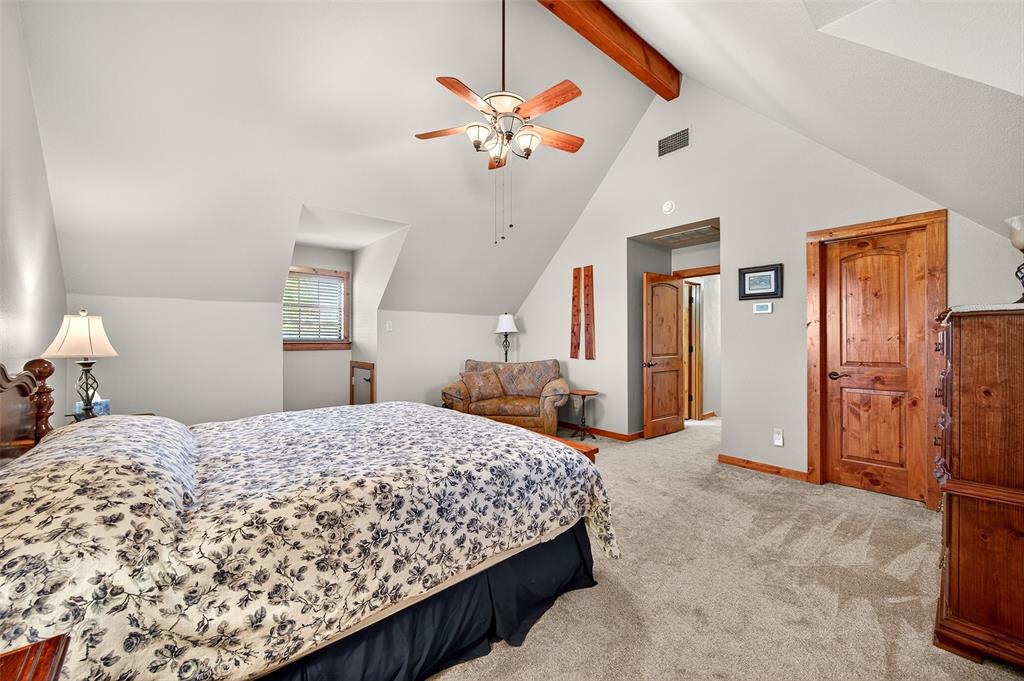 13631 Farm To Market Road 981 Blue Ridge, TX 75424 - Photo 29 of 40 a bedroom with a large bed and a chandelier