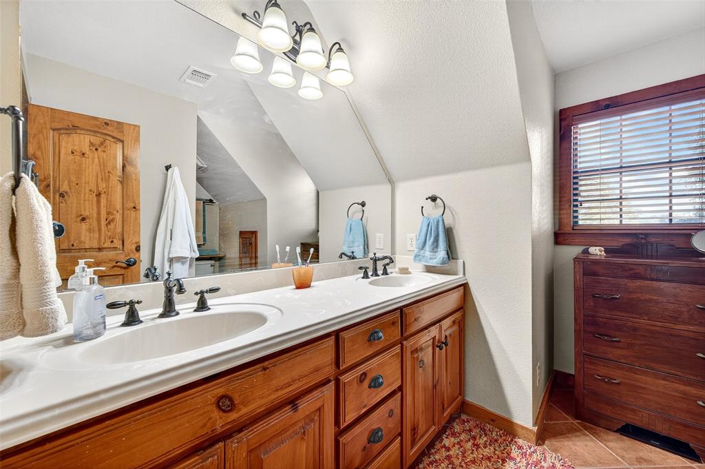 13631 Farm To Market Road 981 Blue Ridge, TX 75424 - Photo 32 of 40 a bathroom with a sink double vanity and a mirror
