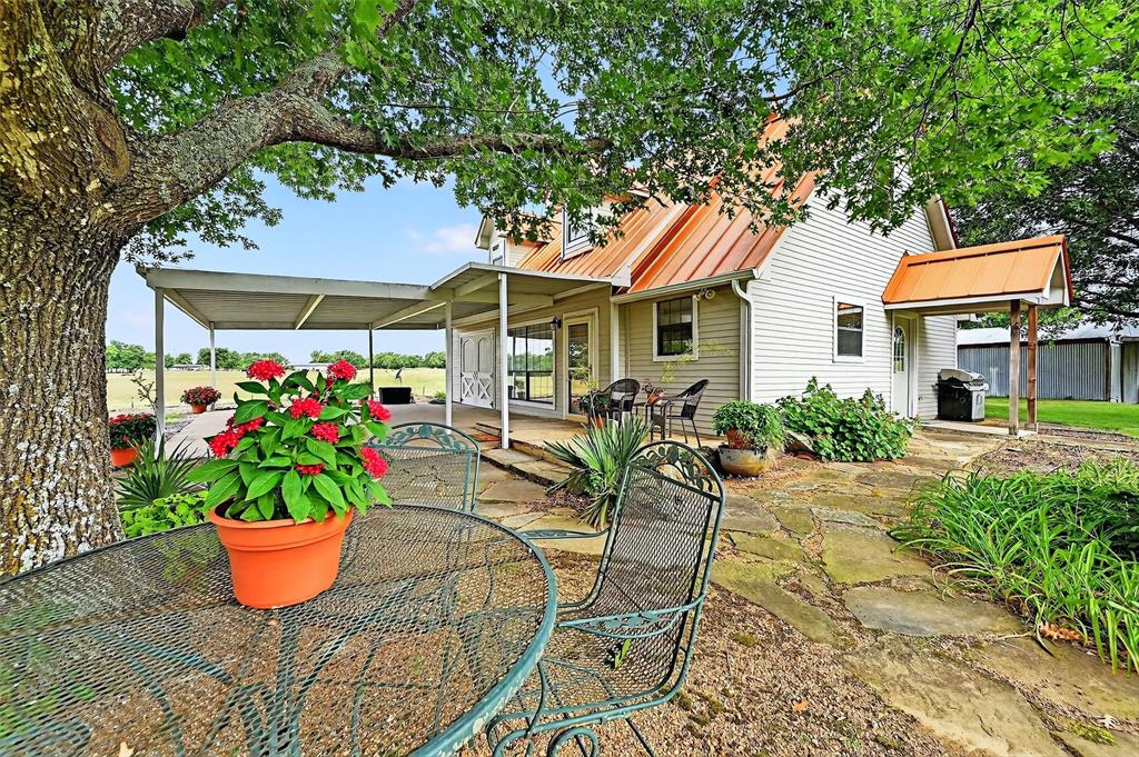 13631 Farm To Market Road 981 Blue Ridge, TX 75424 - Photo 4 of 40 a view of a patio with table and chairs potted plants