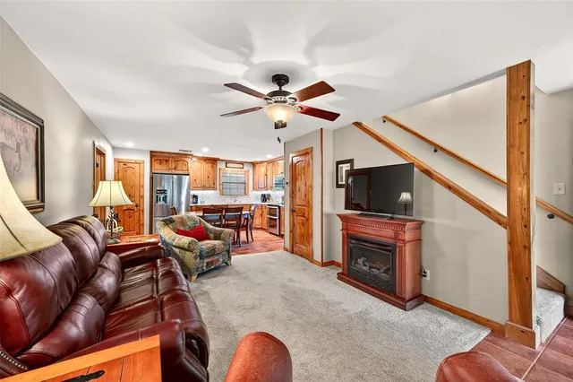 a living room with furniture a flat screen tv and a fireplace