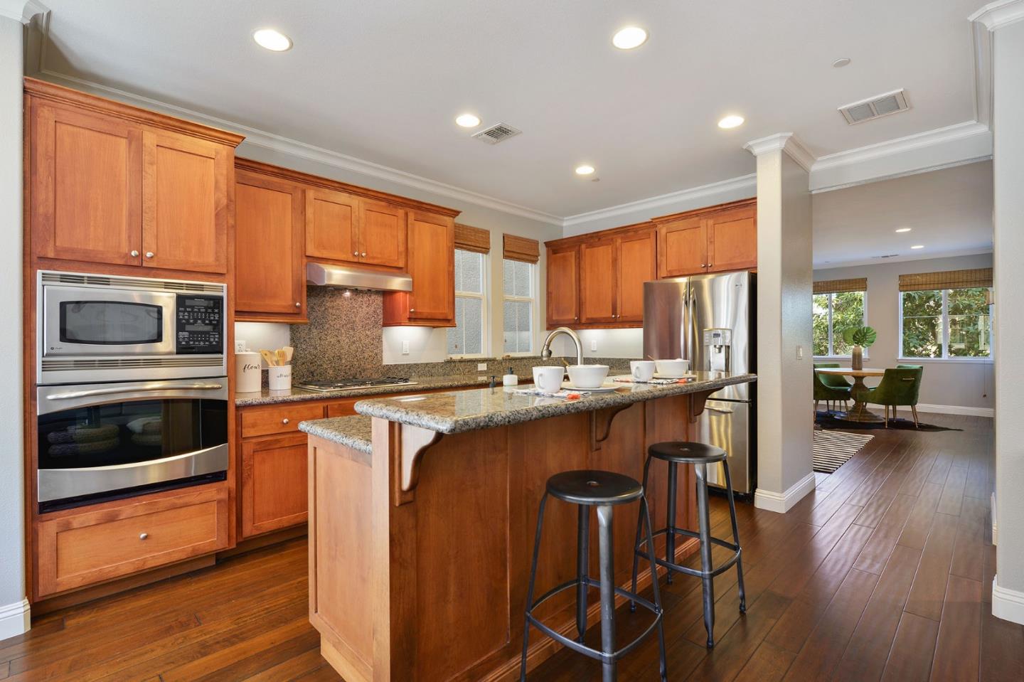 142 Azalea Drive Mountain View, CA 94041 - Photo 11 of 34 a kitchen with stainless steel appliances granite countertop a stove a sink a refrigerator and cabinets
