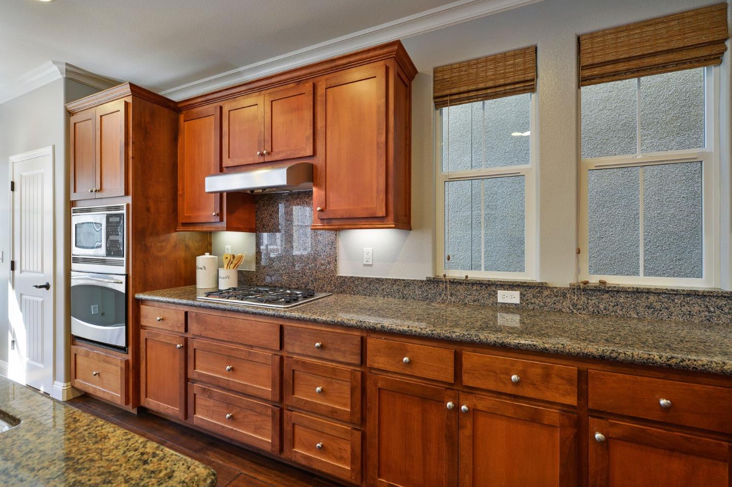 142 Azalea Drive Mountain View, CA 94041 - Photo 14 of 34 a kitchen with stainless steel appliances granite countertop a refrigerator and cabinets