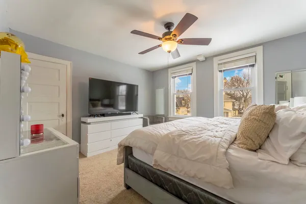 a bedroom with a bed and a flat screen tv