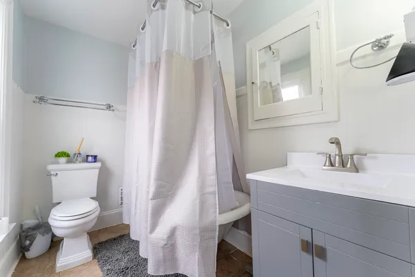 a white toilet sitting next to a bathroom sink