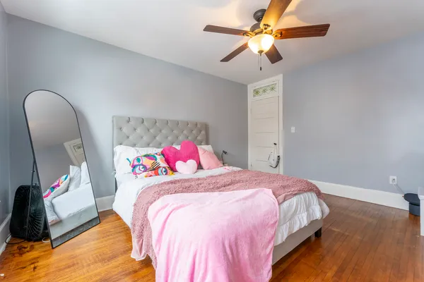 a bedroom with a bed and a chandelier