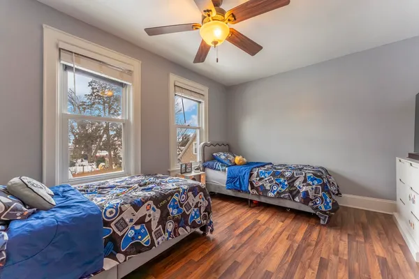 a bedroom with two beds and a chandelier