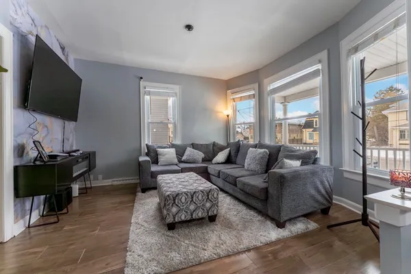 a living room with furniture and a flat screen tv