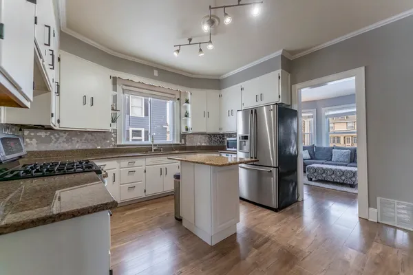 a kitchen with a refrigerator stove and sink