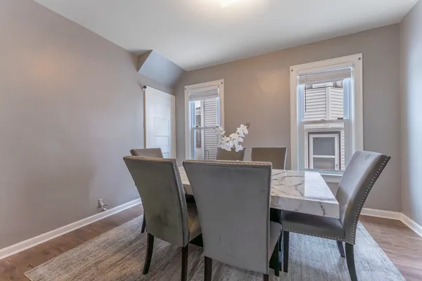 a view of a dining room with furniture window and wooden floor
