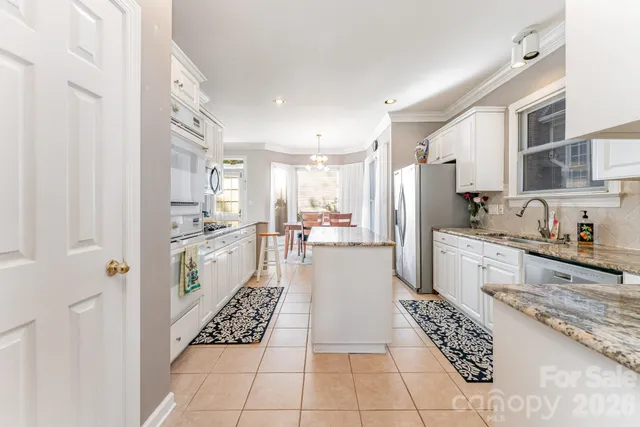 a large white kitchen with cabinets