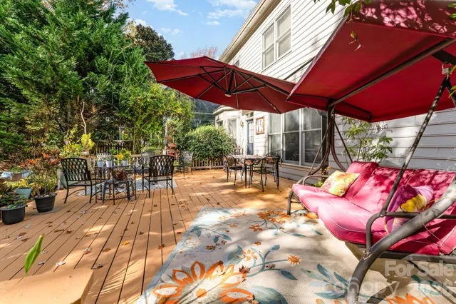 a view of a backyard with a patio and outdoor seating