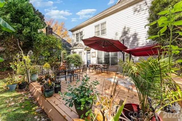 a view of a patio with table and chairs under an umbrella