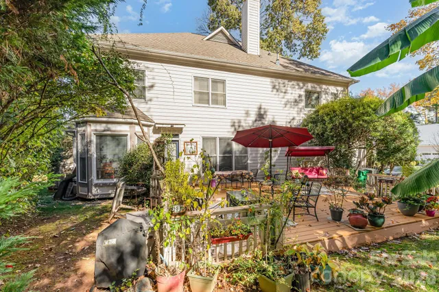 a view of a patio with table and chairs under an umbrella