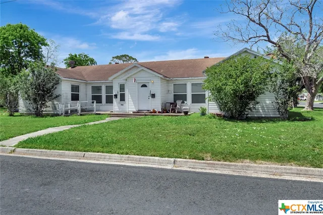 a front view of house with yard and green space